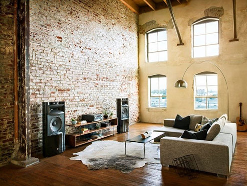 Industrial look of family room with big speakers