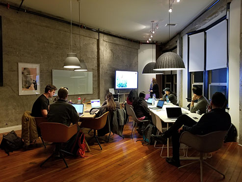 People sitting in a conference room with their laptops