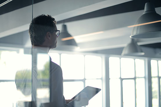 A man holidng a panel in a conference room